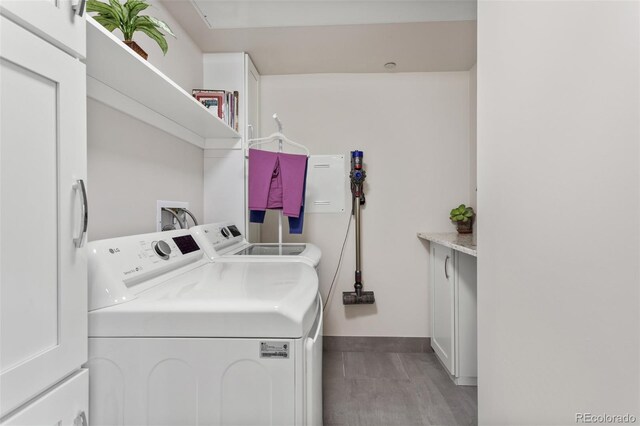 2500 E Cherry Creek S Drive 313, Denver, CO 80209 - laundry room with independent washer and dryer, baseboards, and wood finished floors