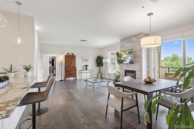 2500 E Cherry Creek S Drive 313, Denver, CO 80209 - dining room with a tile fireplace, dark wood-style floors, and baseboards