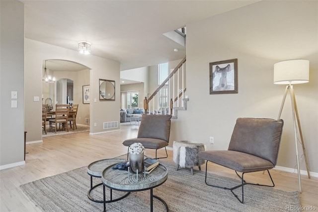 10725 Black Elk Way, Colorado Springs, CO 80908 - sitting room with light wood-style floors, arched walkways, and stairway