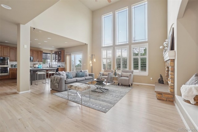 10725 Black Elk Way, Colorado Springs, CO 80908 - living area with light wood-style floors, a high ceiling, and recessed lighting
