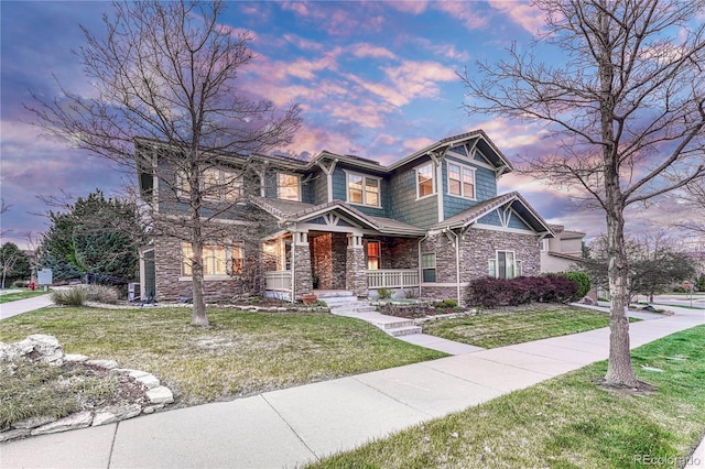 10459 Rivington Ct, Lone Tree, CO 80124 - craftsman-style home with stone siding, covered porch, and a yard