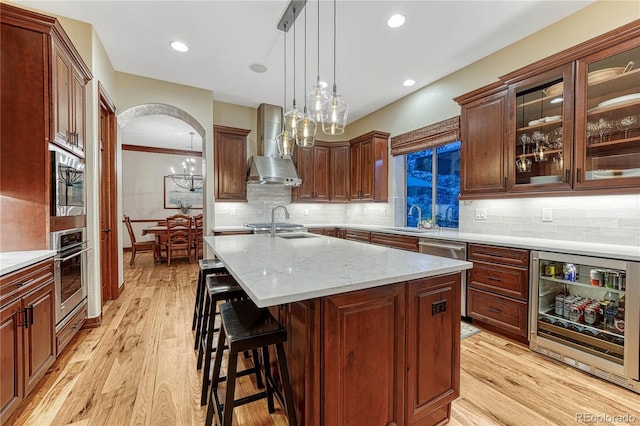 10459 Rivington Ct, Lone Tree, CO 80124 - kitchen featuring wall chimney exhaust hood, stainless steel appliances, a sink, beverage cooler, and decorative backsplash