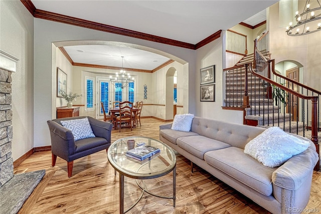 10459 Rivington Ct, Lone Tree, CO 80124 - living room with a chandelier, arched walkways, wood finished floors, ornamental molding, and stairway