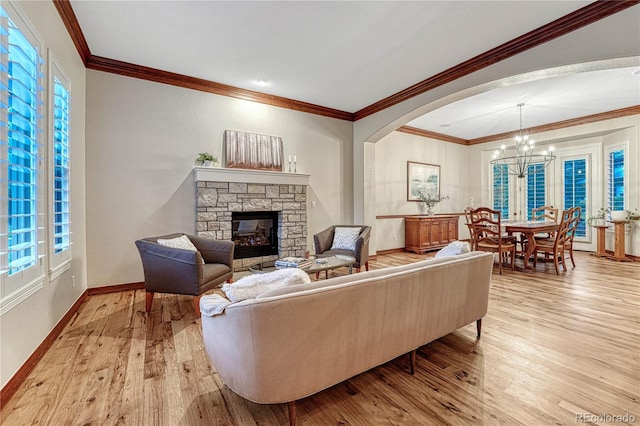 10459 Rivington Ct, Lone Tree, CO 80124 - living room featuring a chandelier, a fireplace, light wood-style floors, baseboards, and healthy amount of natural light