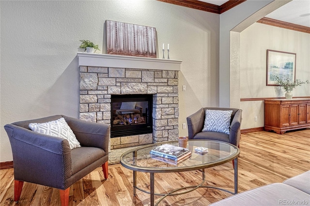 10459 Rivington Ct, Lone Tree, CO 80124 - living room featuring wood finished floors, a textured wall, crown molding, baseboards, and a stone fireplace