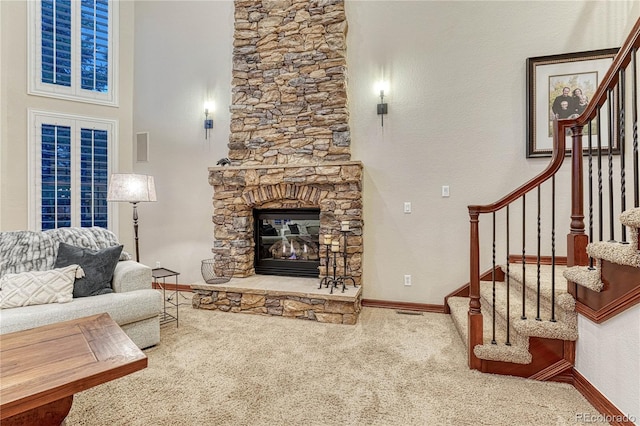 10459 Rivington Ct, Lone Tree, CO 80124 - unfurnished living room featuring carpet floors, stairs, a stone fireplace, and baseboards