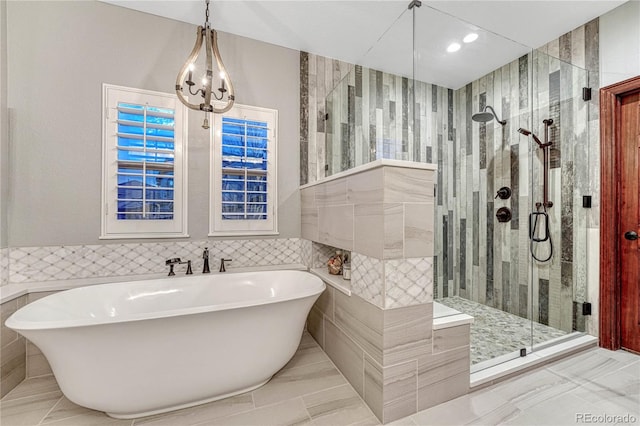 10459 Rivington Ct, Lone Tree, CO 80124 - full bath with a soaking tub, tile walls, a shower stall, recessed lighting, and a chandelier