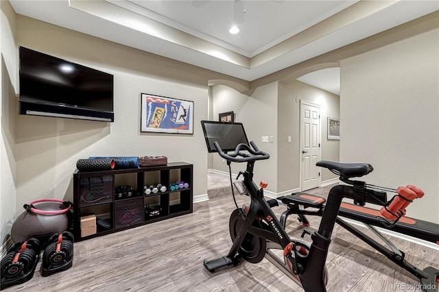 10459 Rivington Ct, Lone Tree, CO 80124 - workout area with arched walkways, wood finished floors, ornamental molding, baseboards, and a tray ceiling