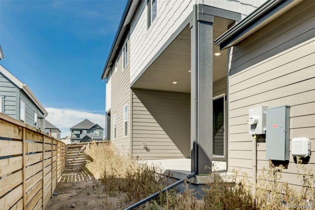 view of side of property featuring fence