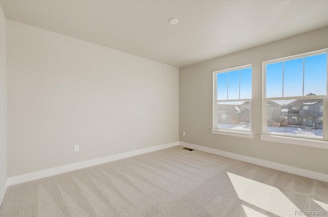 empty room with carpet and baseboards