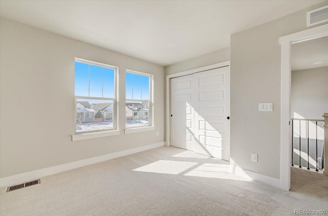 unfurnished bedroom featuring carpet, a closet, and baseboards