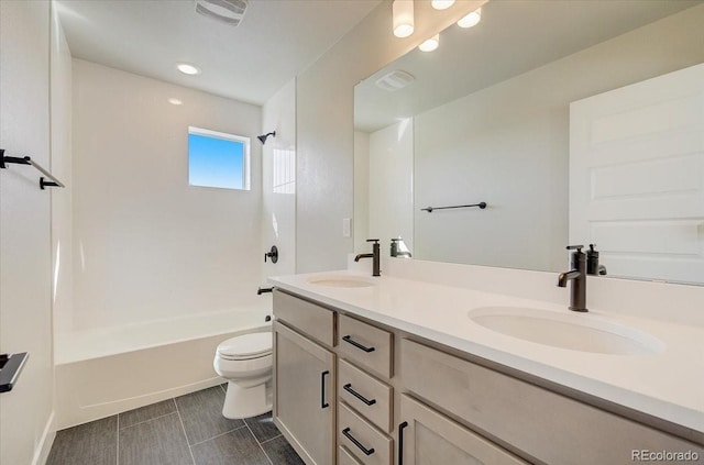 full bathroom with toilet, double vanity, tub / shower combination, and recessed lighting