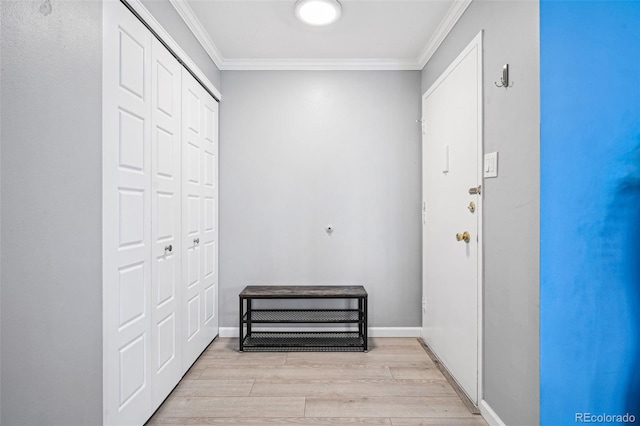 interior space featuring light wood finished floors, baseboards, and crown molding