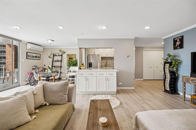 living area with light wood-type flooring, crown molding, and a wall mounted AC