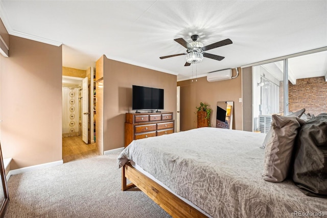 bedroom featuring a ceiling fan, a wall unit AC, crown molding, and baseboards