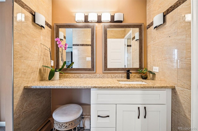 bathroom with tile walls and vanity