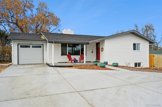 ranch-style house with a porch and a garage