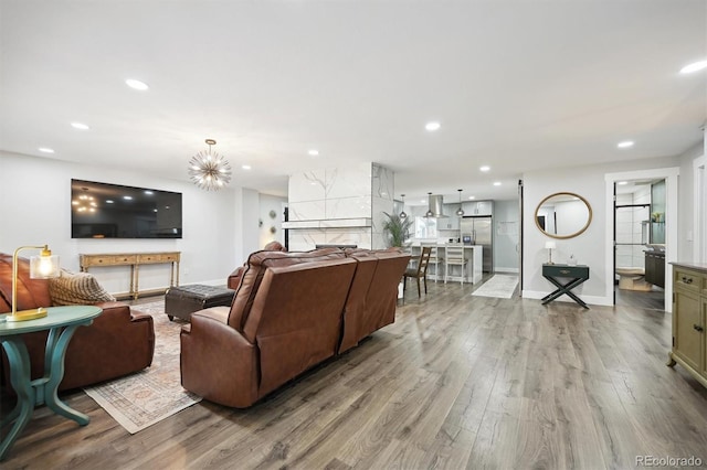 living room featuring light wood-type flooring and a notable chandelier