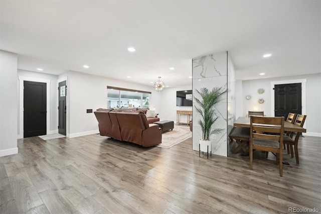 living room featuring a chandelier and wood-type flooring