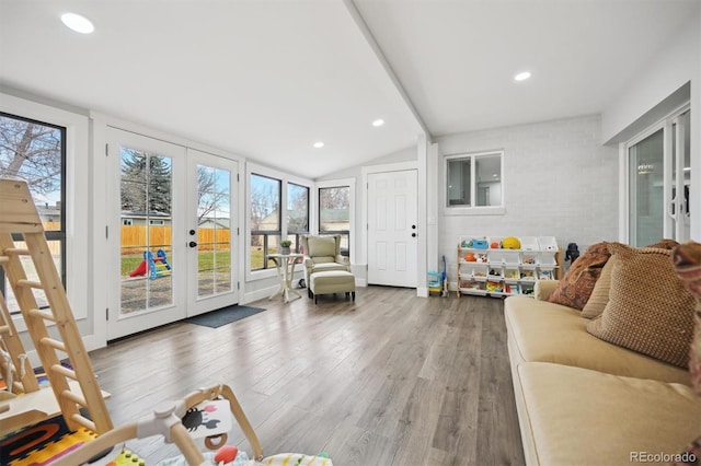 living room featuring french doors, vaulted ceiling, and hardwood / wood-style flooring