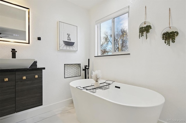 bathroom featuring ceiling fan, a bath, and vanity