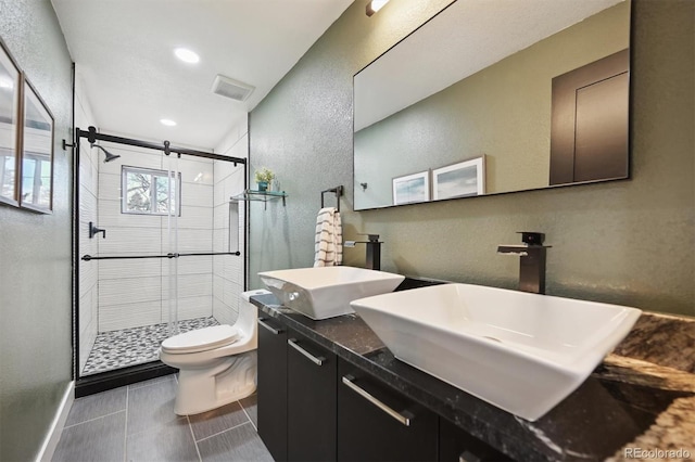 bathroom featuring walk in shower, tile patterned flooring, vanity, and toilet