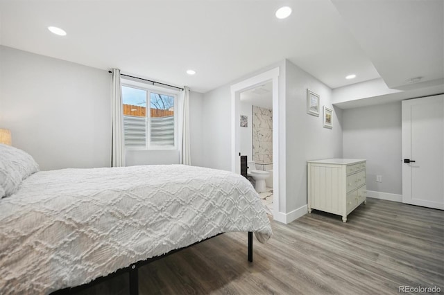 bedroom with hardwood / wood-style floors and connected bathroom