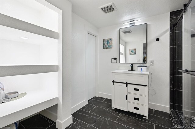 bathroom with a textured ceiling and vanity