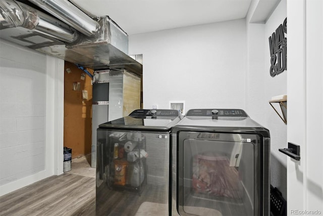 washroom with separate washer and dryer and hardwood / wood-style floors