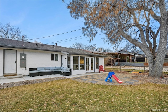 back of property featuring a patio area, french doors, a yard, and an outdoor living space