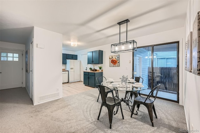 dining area with light carpet