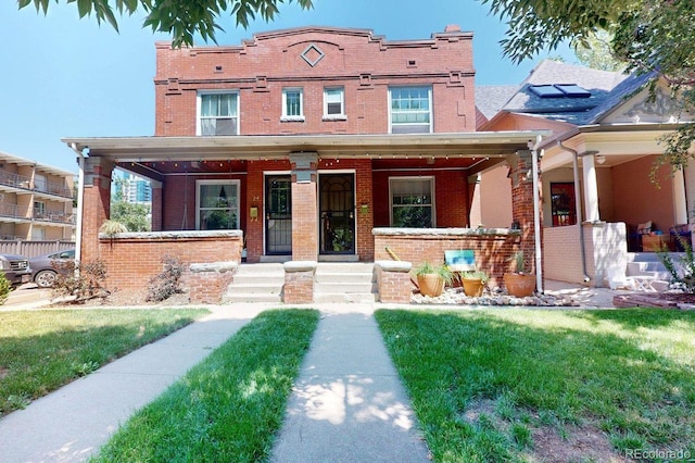 126 S Clarkson St, Denver, CO 80209 - view of front of property featuring brick siding, a porch, and a front yard