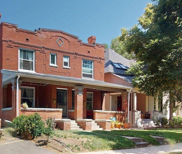 126 S Clarkson St, Denver, CO 80209 - view of front of property with a porch, brick siding, and a chimney