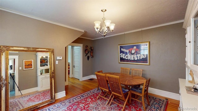 126 S Clarkson St, Denver, CO 80209 - dining space featuring a chandelier, light wood finished floors, and ornamental molding