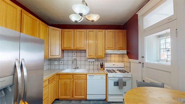 126 S Clarkson St, Denver, CO 80209 - kitchen with white appliances, tile countertops, under cabinet range hood, and tasteful backsplash