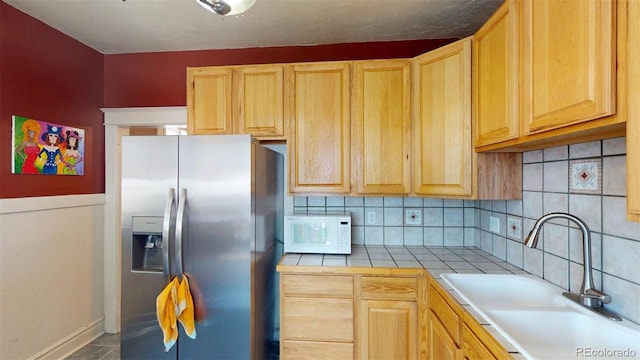 126 S Clarkson St, Denver, CO 80209 - kitchen featuring stainless steel refrigerator with ice dispenser, white microwave, and light brown cabinetry