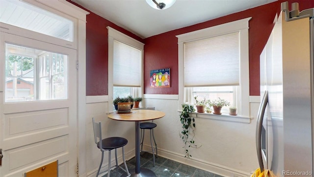 126 S Clarkson St, Denver, CO 80209 - tiled dining space featuring healthy amount of natural light and wainscoting