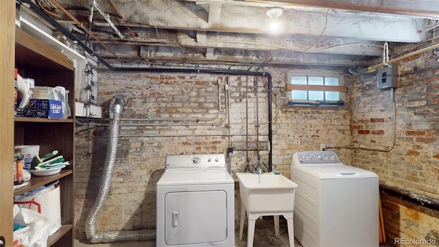 126 S Clarkson St, Denver, CO 80209 - laundry area with washer and dryer and brick wall
