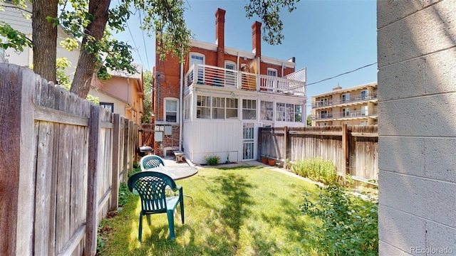 126 S Clarkson St, Denver, CO 80209 - back of property featuring a fenced backyard and a balcony