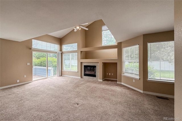1419 Red Mountain Dr Unit 126, Longmont, CO 80504 - unfurnished living room featuring ceiling fan, healthy amount of natural light, carpet flooring, a textured ceiling, and high vaulted ceiling