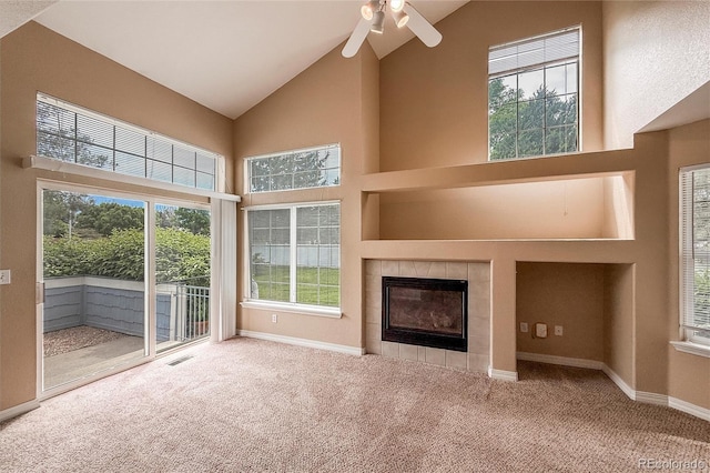 1419 Red Mountain Dr Unit 126, Longmont, CO 80504 - unfurnished living room with high vaulted ceiling, carpet flooring, ceiling fan, and a tile fireplace