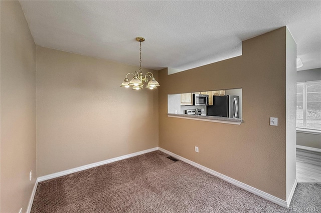 1419 Red Mountain Dr Unit 126, Longmont, CO 80504 - carpeted spare room with a chandelier and a textured ceiling