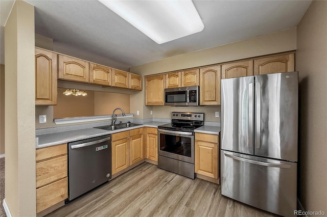 1419 Red Mountain Dr Unit 126, Longmont, CO 80504 - kitchen with stainless steel appliances, light wood-style floors, light countertops, and light brown cabinets