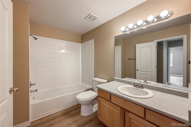 1419 Red Mountain Dr Unit 126, Longmont, CO 80504 - bathroom with wood finished floors, vanity, a textured wall, shower / washtub combination, and a textured ceiling