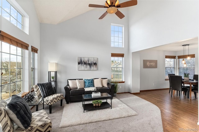 7636 S Allison Ct, Littleton, CO 80128 - living room featuring high vaulted ceiling, healthy amount of natural light, ceiling fan, and wood finished floors