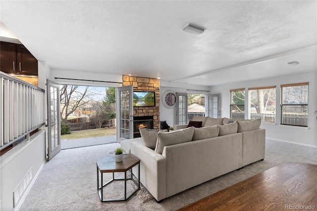 7636 S Allison Ct, Littleton, CO 80128 - living area with a textured ceiling, carpet floors, plenty of natural light, and a fireplace