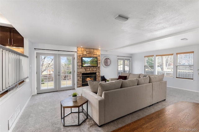7636 S Allison Ct, Littleton, CO 80128 - living room featuring a textured ceiling, carpet floors, french doors, and a fireplace