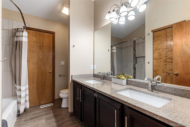 7636 S Allison Ct, Littleton, CO 80128 - bathroom with double vanity, wood finished floors, shower / tub combo, and vaulted ceiling