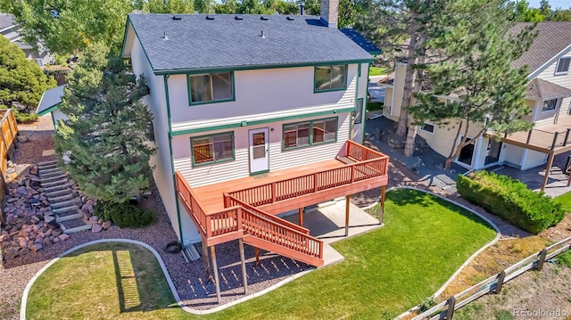 back of property with a patio, a yard, and a wooden deck