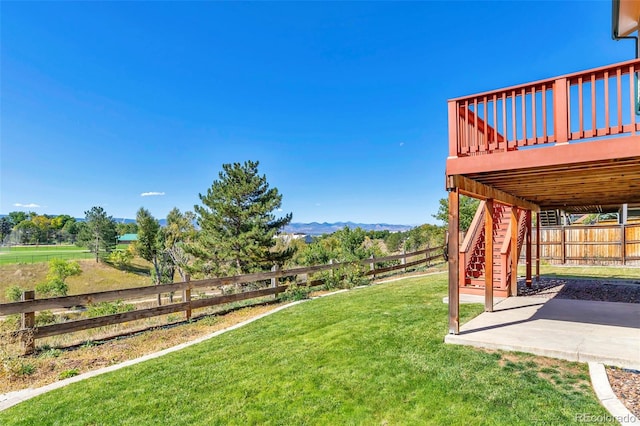 view of yard with a patio and a wooden deck